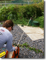 Staff measuring the water level in a deep monitor well at Iao, Maui.